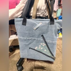 Handmade denim tote with embroidery.